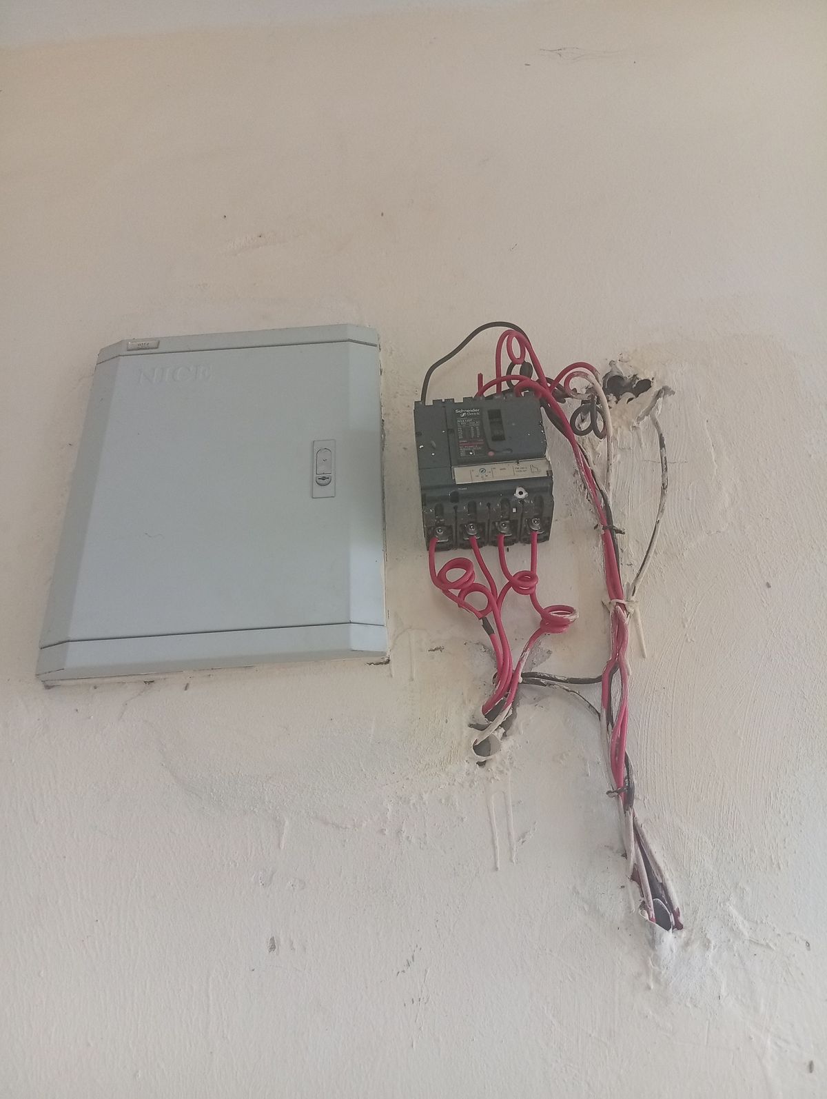 Circuit breaker mounted in a panel next to its wiring, the type of breaker we replace