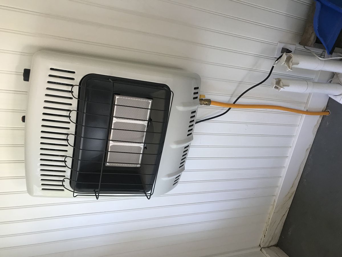 Electric wall heater mounted on an interior wall