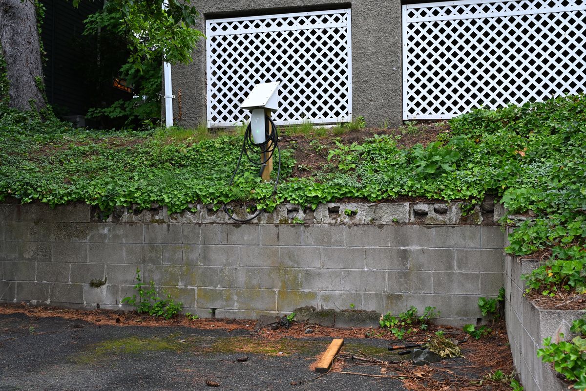 EV charging wall connector installed on an exterior wall