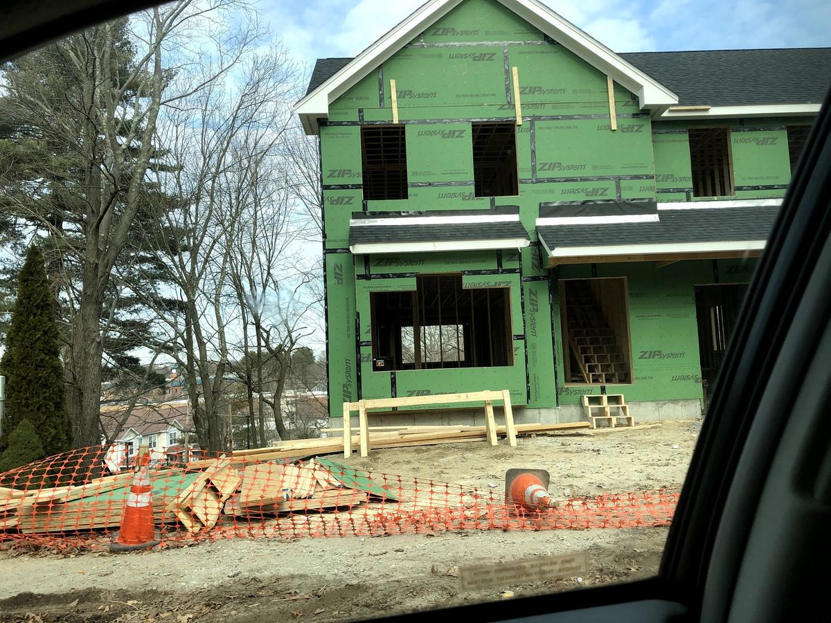 New home addition under construction with framing and sheathing in place