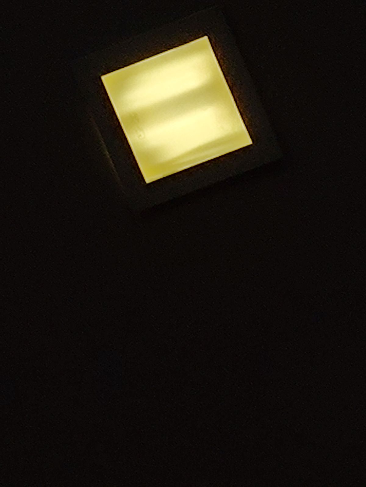 Recessed ceiling light fixture installed and illuminated